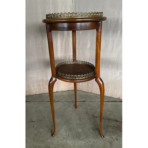 169 - A mahogany two tier table with brass gallery. 77cm h x 34 d.