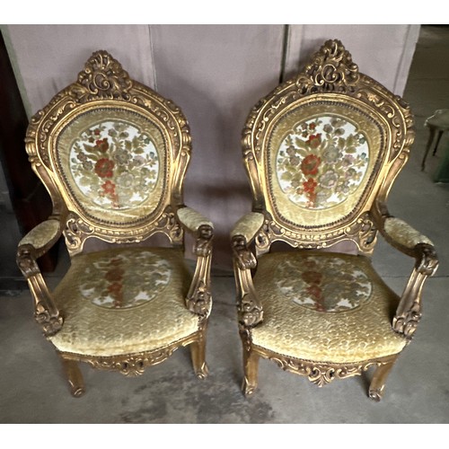 170 - A pair of ornately carved gilt upholstered open armchairs. 118cm h x 70 w x 63 d.