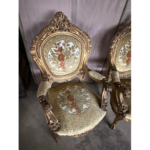 170 - A pair of ornately carved gilt upholstered open armchairs. 118cm h x 70 w x 63 d.