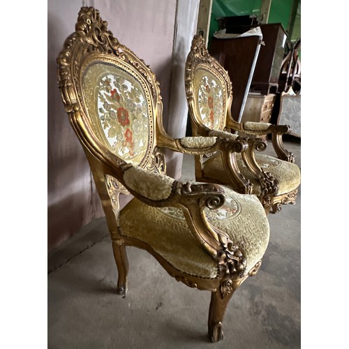 170 - A pair of ornately carved gilt upholstered open armchairs. 118cm h x 70 w x 63 d.