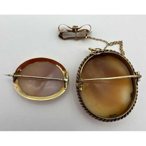 484 - Two oval shell cameo brooches, one with safety chain and bow with metal inner rim, 3.5 x 3cm, the ot... 