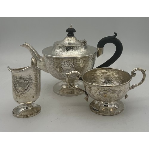 864 - A three piece silver tea set with ebony knop and handle. Birmingham 1908, maker T.H. Hazel wood and ... 