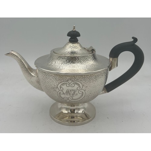 864 - A three piece silver tea set with ebony knop and handle. Birmingham 1908, maker T.H. Hazel wood and ... 