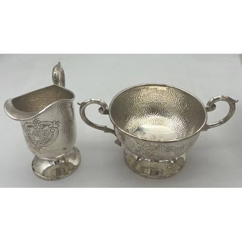 864 - A three piece silver tea set with ebony knop and handle. Birmingham 1908, maker T.H. Hazel wood and ... 