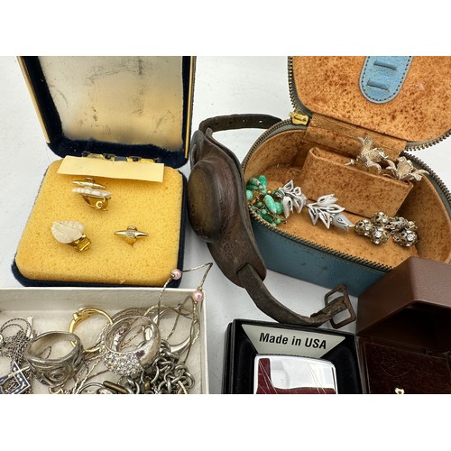 389 - A quantity of vintage costume jewellery to include Zippo lighter, rings, earrings etc.