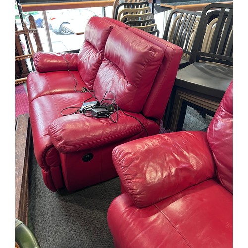 155 - A pair of red leather electric two seater sofas.