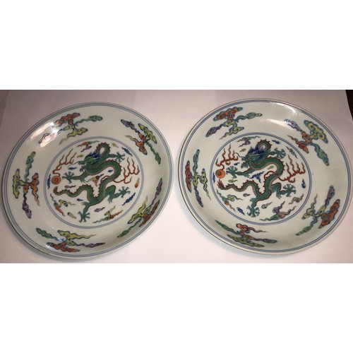14 - A pair of fine and rare doucai 'dragon' saucer dishes. Yongzheng six character mark and of the perio... 