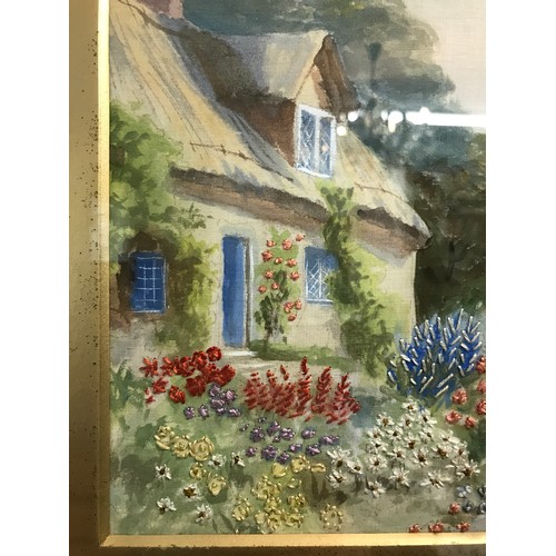 35 - A painted silk of a cottage scene with embroidered floral detail. Image size 19 x 24cm.