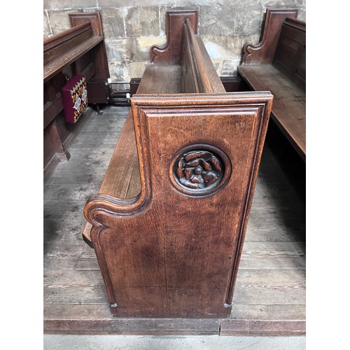 139 - A 19thC oak pew with floral roundel to one end by Sir George Gilbert Scott. 244 L x 96h x 52cm d.

P... 