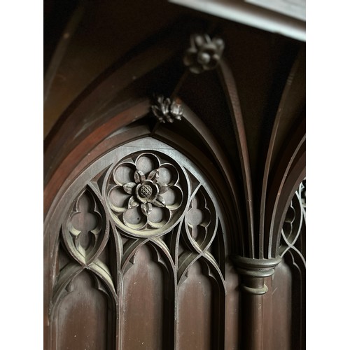 165 - The vicar’s stall ex Beverley Minster,  heavily carved in oak with gothic arches and Yorkshire rose,... 