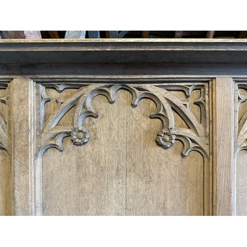 171 - Two carved oak panels, pew fronts, sloping shelf to top, each panel 141cm w approx. X 84cm h with sp... 