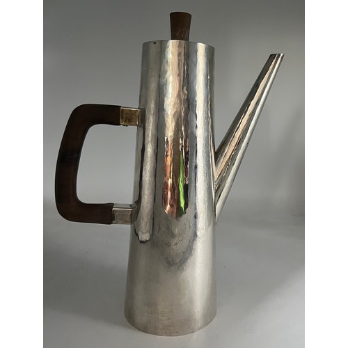 74 - A planished silver coffee pot with wooden handle and knop  London 1977 with Jubilee mark by Geoffrey... 