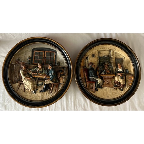 75 - A pair of Musterscutz relief moulded wall plaques depicting tavern scenes. 33cm d.