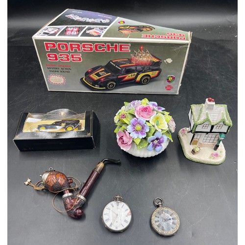 76 - A miscellany of items to include a battery operated Porsche 935, Ringtons Tea Classix Collection van... 