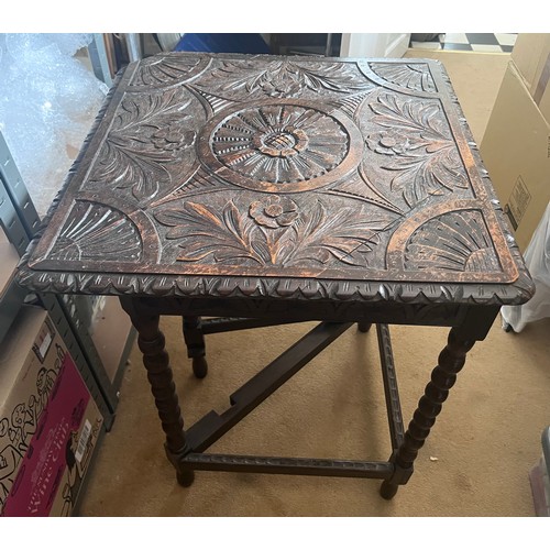 78 - An oak triangular gateleg table with decorative carving to top. 60 x 60cm.