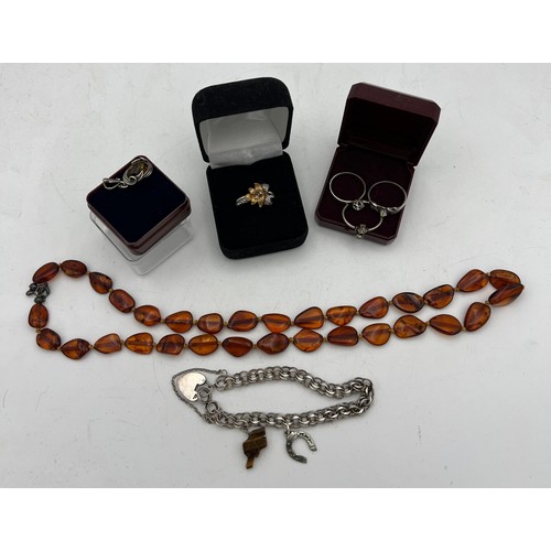 84 - A quantity of vintage jewellery to include an amber bead necklace, amber and silver pendant, silver ... 