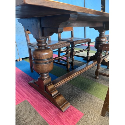 7 - A oak refectory dining table together with 6 oak and leather chairs to include 2 carvers. 183 l x 76... 