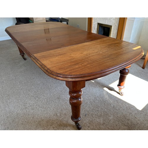 27 - Mahogany wind out table with two extra leaves, with porcelain castors and winder closed 136cm long x... 