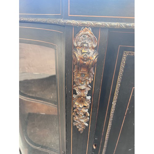 29 - A two door ebonized credenza with gilt metal mounts. 150 w x 39 d x 100cm h.