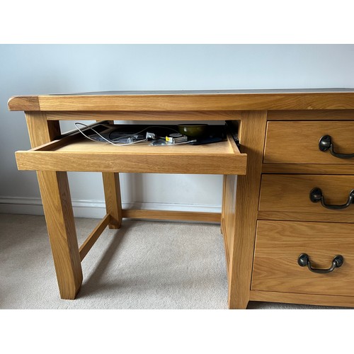 39 - Oak kneehole desk with three drawers to side and leather top. 130cm w x 67cm d x 78cm h.