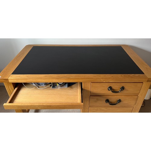 39 - Oak kneehole desk with three drawers to side and leather top. 130cm w x 67cm d x 78cm h.