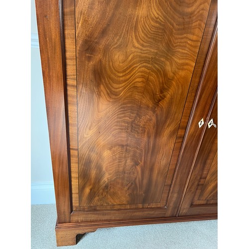 41 - A two door mahogany cupboard on later bracket feet 129cm h x 120cm w x 27cm d