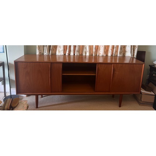 49 - A teak sideboard by Axel Christensen for Aco Møbler, Danish, mid century. Four sliding doors to fron... 