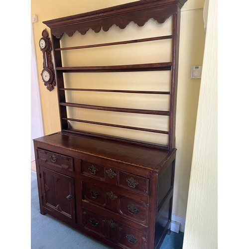 51 - An 18thC oak dresser comprising four drawers and one cupboard with rack to back. 125cm w x 45d x 190... 