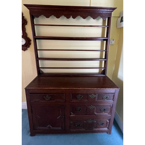 51 - An 18thC oak dresser comprising four drawers and one cupboard with rack to back. 125cm w x 45d x 190... 