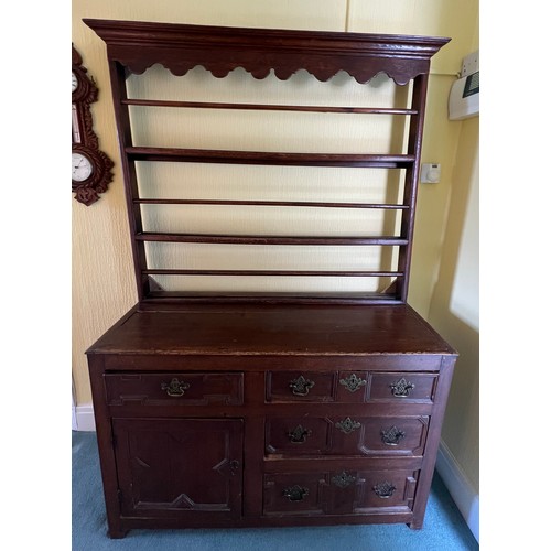 51 - An 18thC oak dresser comprising four drawers and one cupboard with rack to back. 125cm w x 45d x 190... 