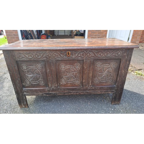 58 - An 18thC oak panelled kist with carving to front. 72h x 130w x 58d.