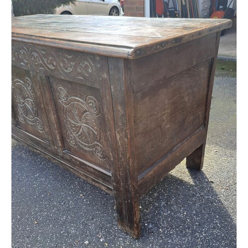 58 - An 18thC oak panelled kist with carving to front. 72h x 130w x 58d.