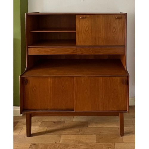 60 - A mid 20thC teak unit comprising two cupboards, two drawers and a drinks cabinet. 122cm w x 44cm d x... 