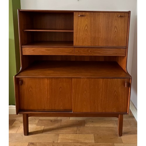 60 - A mid 20thC teak unit comprising two cupboards, two drawers and a drinks cabinet. 122cm w x 44cm d x... 