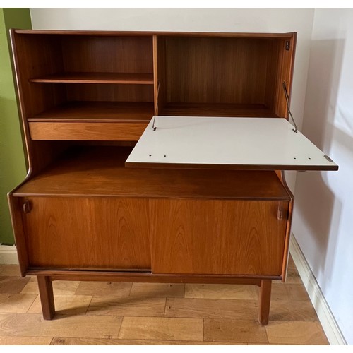 60 - A mid 20thC teak unit comprising two cupboards, two drawers and a drinks cabinet. 122cm w x 44cm d x... 