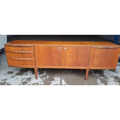 64 - A mid 20thC AH McIntosh Ltd teak sideboard. Three drawers and three cupboards. 213cm l x 45cm d x 75... 