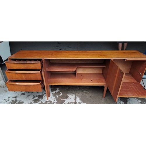 64 - A mid 20thC AH McIntosh Ltd teak sideboard. Three drawers and three cupboards. 213cm l x 45cm d x 75... 