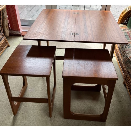 66 - A mid 20thC McIntosh teak nest of three tables. The largest of which turns and opens to 74cm x 81cm ... 