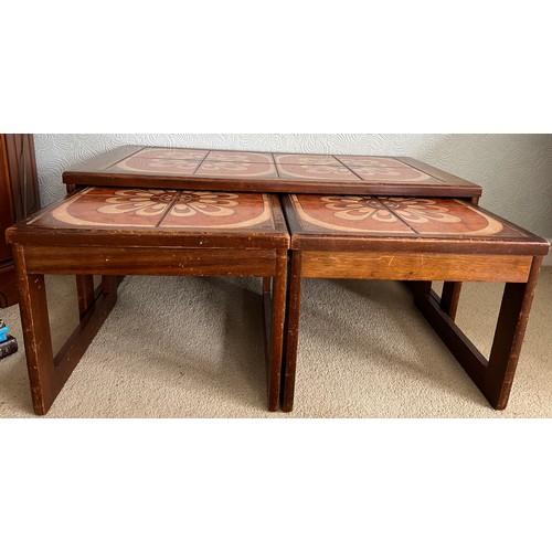 68 - A nest of three mid 20thC tile topped tables. Largest 96cm x 48cm x 40cm h.