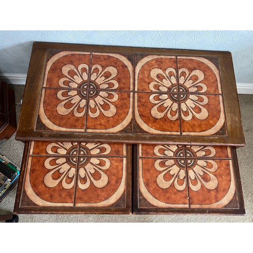 68 - A nest of three mid 20thC tile topped tables. Largest 96cm x 48cm x 40cm h.