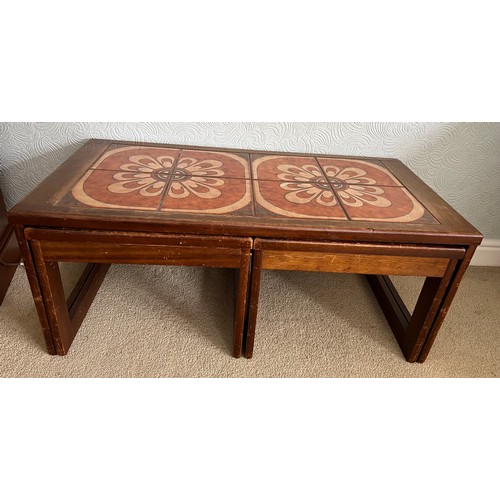 68 - A nest of three mid 20thC tile topped tables. Largest 96cm x 48cm x 40cm h.