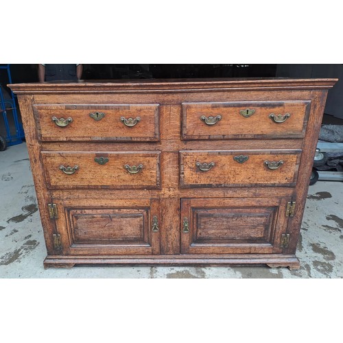 74 - A Georgian oak dresser base with cross banding to drawers and brass handles. 135cm w 52cms d x 93cm ... 