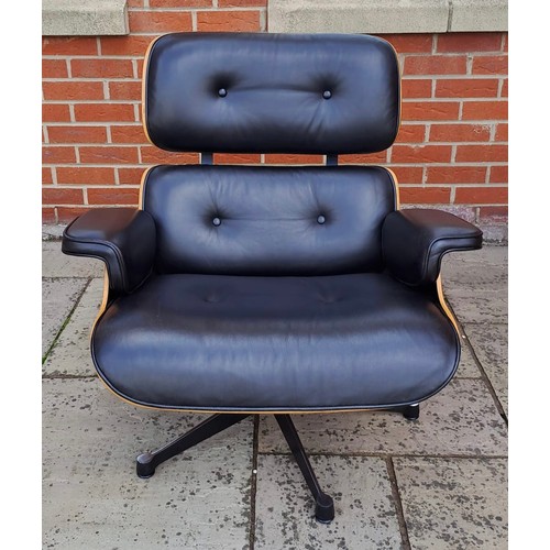 75 - An Eames style armchair covered in black leather. 82cm h x 85cm w x 72cm d.