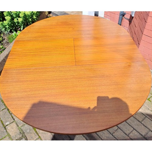 77 - A mid 20th Century teak oval extending dining table by McIntosh. 75cm h x 168cm open/122cm closed x ... 