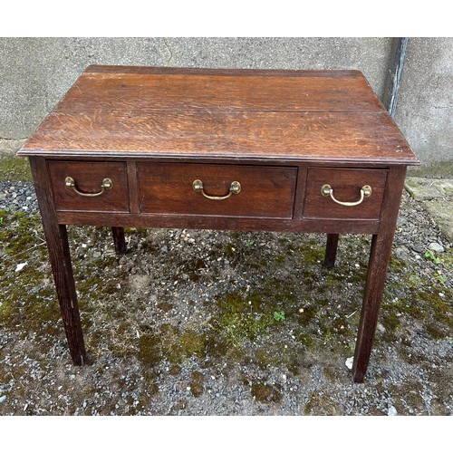 84 - An early 19thC three drawer oak lowboy with drop brass handles. 75cm w x 45cm d x 65cm h.