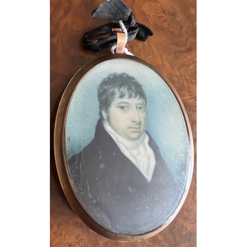 1270 - An oval portrait miniature of a young gentleman with short brown hair wearing a white stock and dark... 