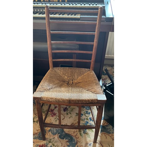 86 - An Arts and Crafts fruitwood single chair with rush seat. 84cm h to back.