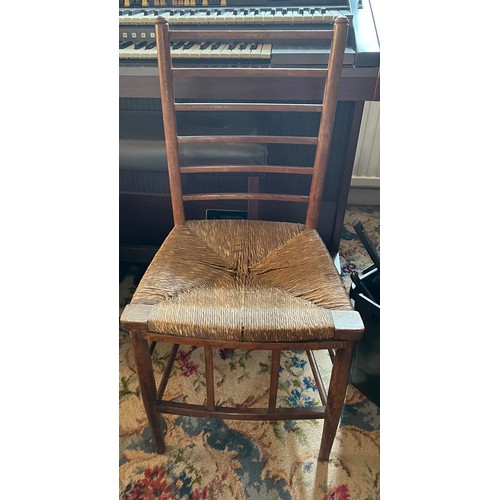 86 - An Arts and Crafts fruitwood single chair with rush seat. 84cm h to back.