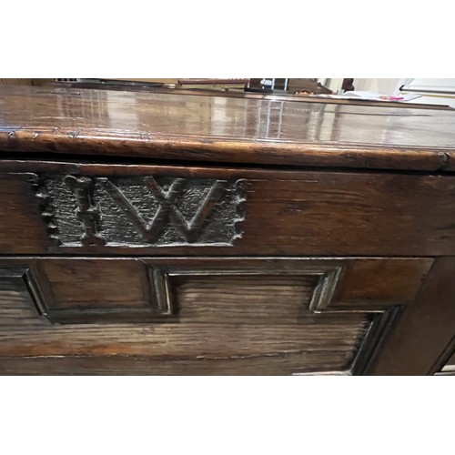 100 - An oak blanket box above four drawers with carved panels. IW 1703 carved into the top. New hinges to... 