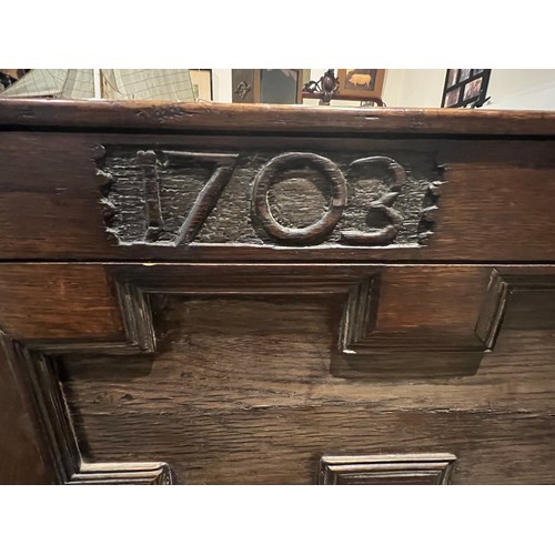 100 - An oak blanket box above four drawers with carved panels. IW 1703 carved into the top. New hinges to... 